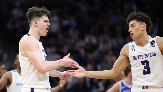 Northwestern Wildcats teammates Brooks Barnhizer and Ty Berry celebrate a win.
